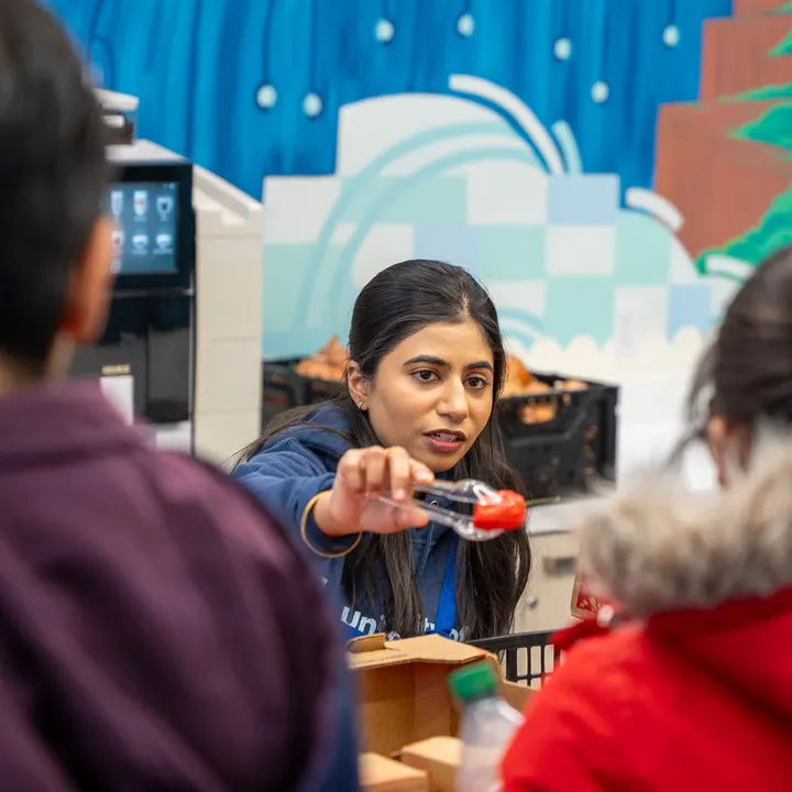 Shiwani serving food to neighbours at a community dinner