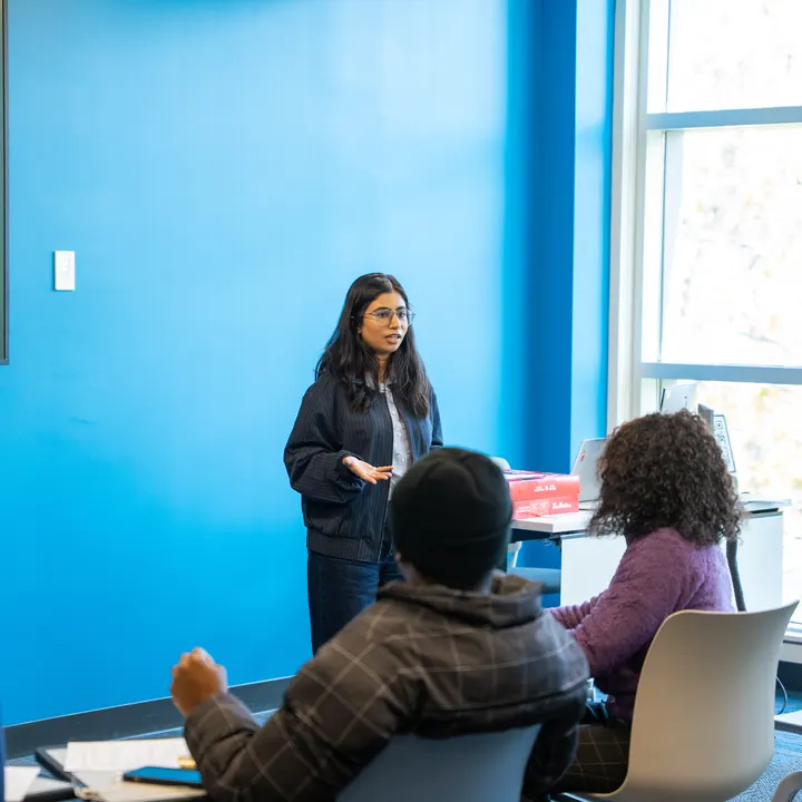 Shiwani speaking with residents at a community session