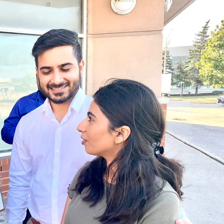 Shiwani in conversation with neighbours outdoors