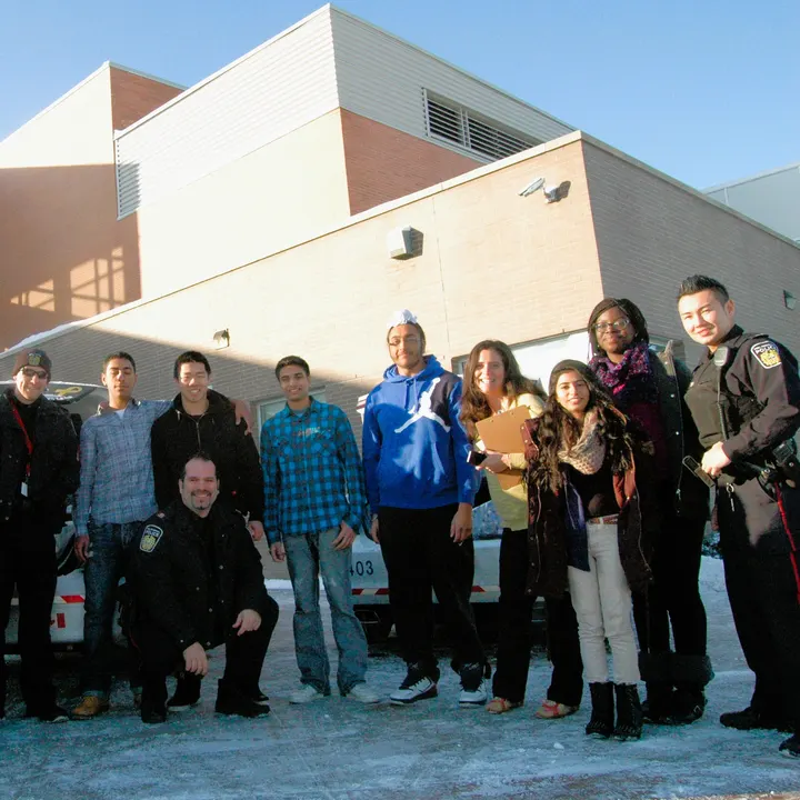 Shiwani at a community safety event with local officers and youth